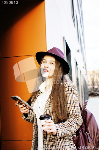 Image of young pretty hipster girl student with coffee cup posing adorable smiling, lifestyle people concept outdoor