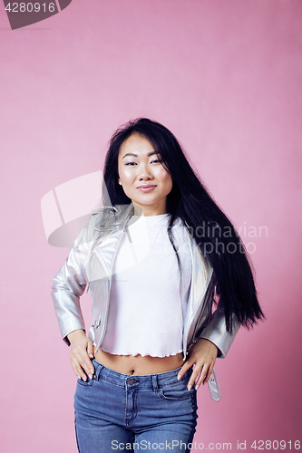 Image of young pretty smiling asian korean girl wearing modern fashion clothers on pink background, lifestyle people concept