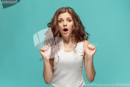 Image of Portrait of young woman with shocked facial expression