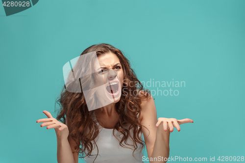 Image of Portrait of young woman with shocked facial expression