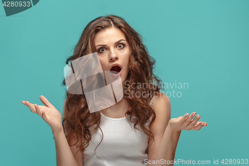 Image of Portrait of young woman with shocked facial expression