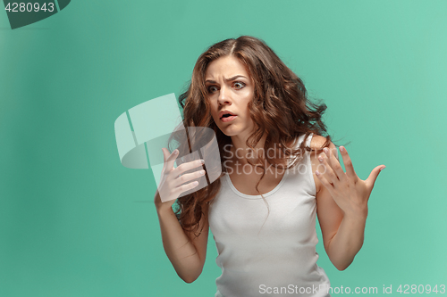 Image of Portrait of young woman with shocked facial expression