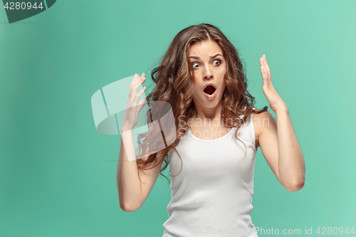 Image of Portrait of young woman with shocked facial expression