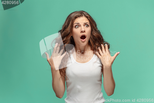 Image of Portrait of young woman with shocked facial expression