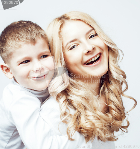 Image of young modern blond mother with cute son together happy smiling family posing cheerful on white background, lifestyle people concept, sister and brother friends 