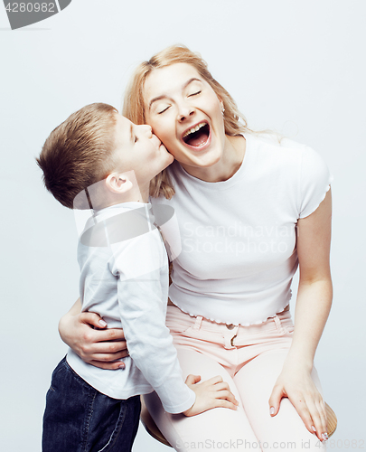 Image of young modern blond mother with cute son together happy smiling family posing cheerful on white background, lifestyle people concept, sister and brother friends 