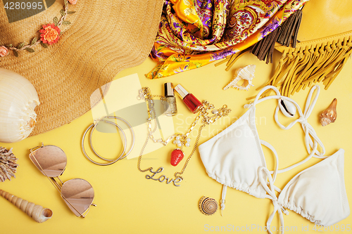 Image of diverse travel girlish stuff on colorful background blue and yellow, nobody tourism lifestyle concept 