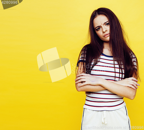 Image of young pretty teenage woman angry posing on yellow background, fashion lifestyle people concept 