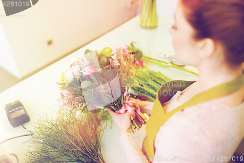 Image of close up of woman making bunch at flower shop