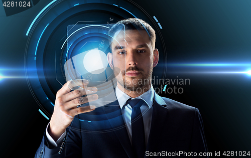 Image of businessman working with transparent tablet pc