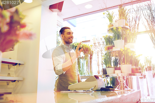 Image of florist man or seller at flower shop counter