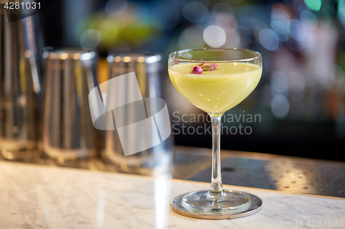 Image of glass of cocktail at bar