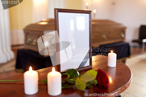 Image of photo frame and coffin at funeral in church