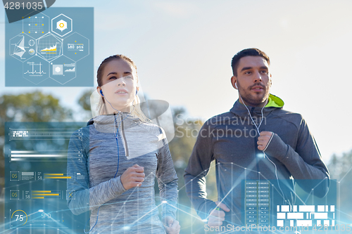 Image of happy couple with earphones running outdoors