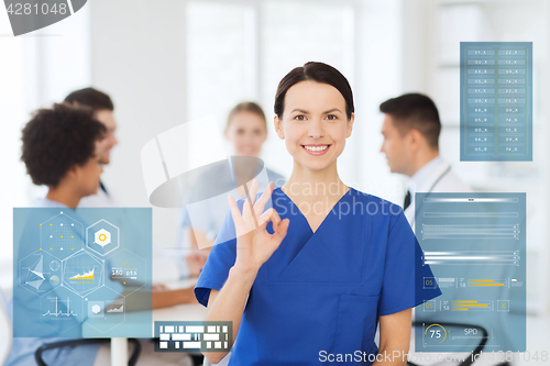 Image of happy doctor at hospital showing ok hand sign