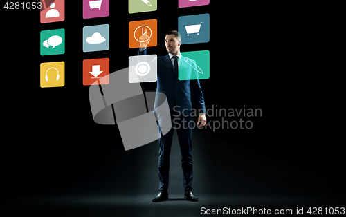 Image of businessman in suit touching virtual menu icons