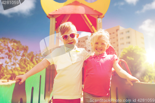 Image of two happy kids hugging on children playground