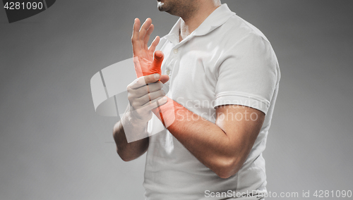 Image of close up of man suffering from pain in hand