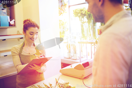 Image of florist woman and man making order at flower shop