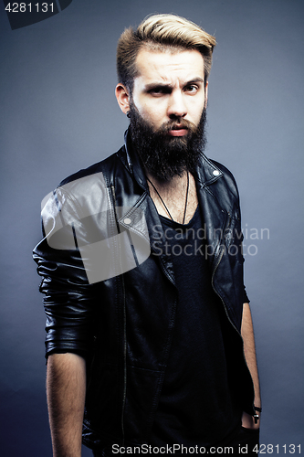Image of portrait of young bearded hipster guy on gray dark background close up, brutal modern man, lifestyle people concept 