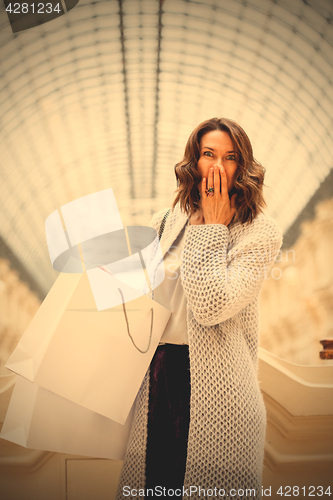 Image of woman with packages in the mall