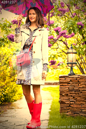 Image of Beautiful woman with an umbrella in the park.