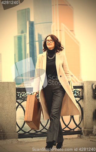 Image of Beautiful businesswoman in a light coat