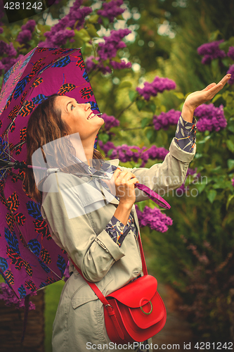 Image of smiling middle-aged woman with an umbrella 