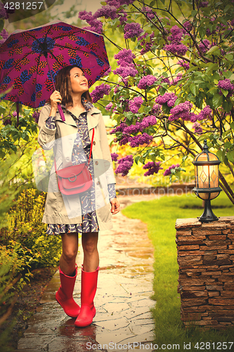 Image of Beautiful woman with an umbrella on a rainy day