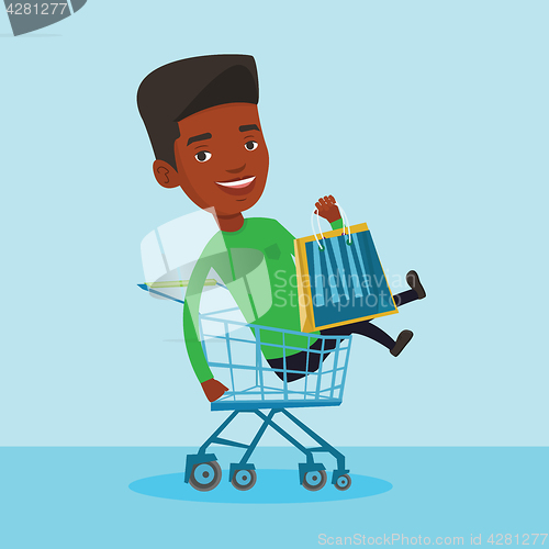 Image of Happy man riding by shopping trolley.