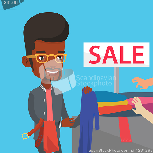 Image of Young man choosing clothes in shop on sale.