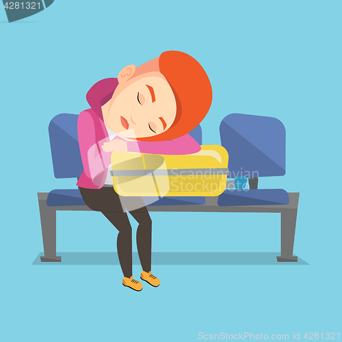 Image of Exhausted woman sleeping on suitcase at airport.