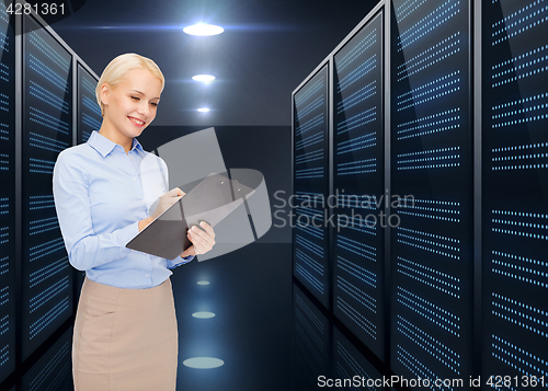 Image of businessman with clipboard over server room