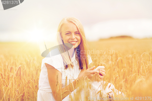 Image of happy woman with smartphone and earphones