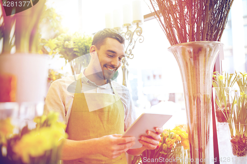 Image of man with tablet pc computer at flower shop