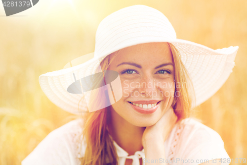 Image of close up of happy woman in sun hat on cereal field