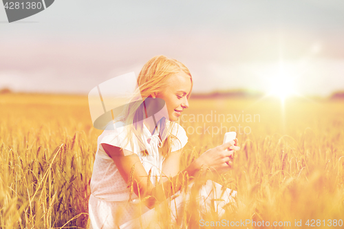 Image of happy woman with smartphone and earphones