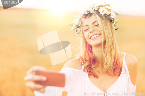 Image of happy young woman taking selfie by smartphone