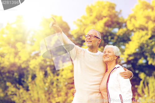 Image of senior couple hugging in park