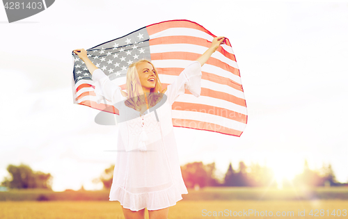 Image of happy woman with american flag on cereal field