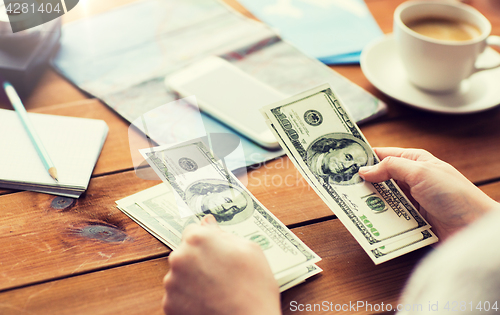 Image of close up of traveler hands counting dollar money