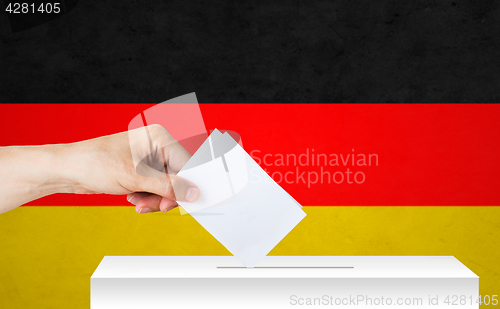 Image of hand of german with ballot and box on election