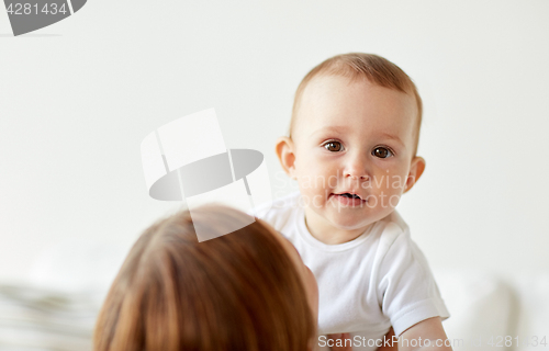 Image of happy little baby with mother at home