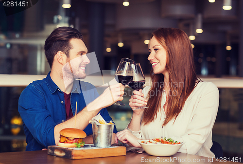 Image of happy couple dining and drink wine at restaurant