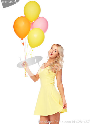 Image of happy woman in dress with helium air balloons