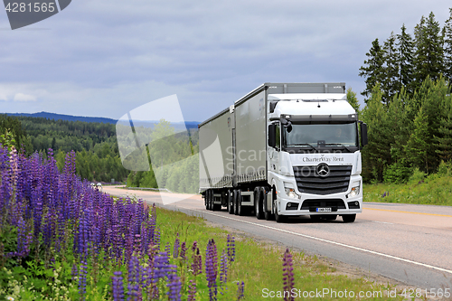 Image of White Mercedes-Benz Actros Cargo Truck on Scenic Road