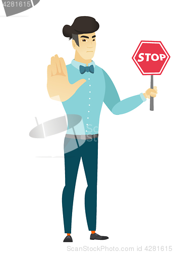 Image of Asian businessman holding stop road sign.