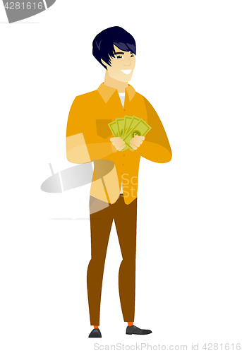 Image of Happy asian businessman holding money.