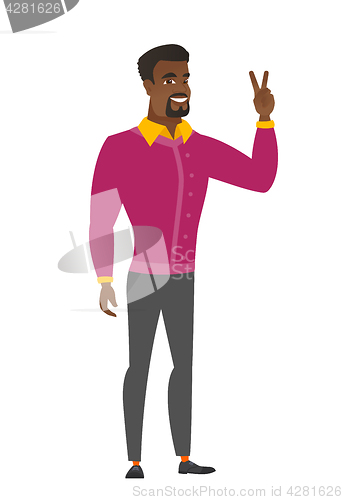 Image of African businessman showing the victory gesture.