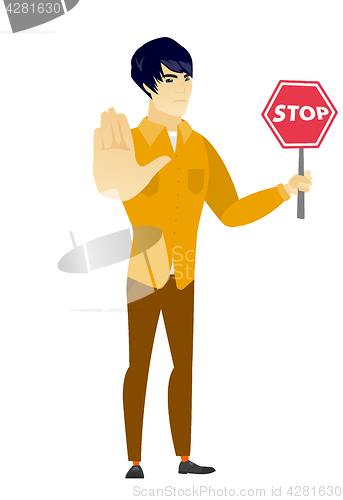 Image of Asian businessman holding stop road sign.